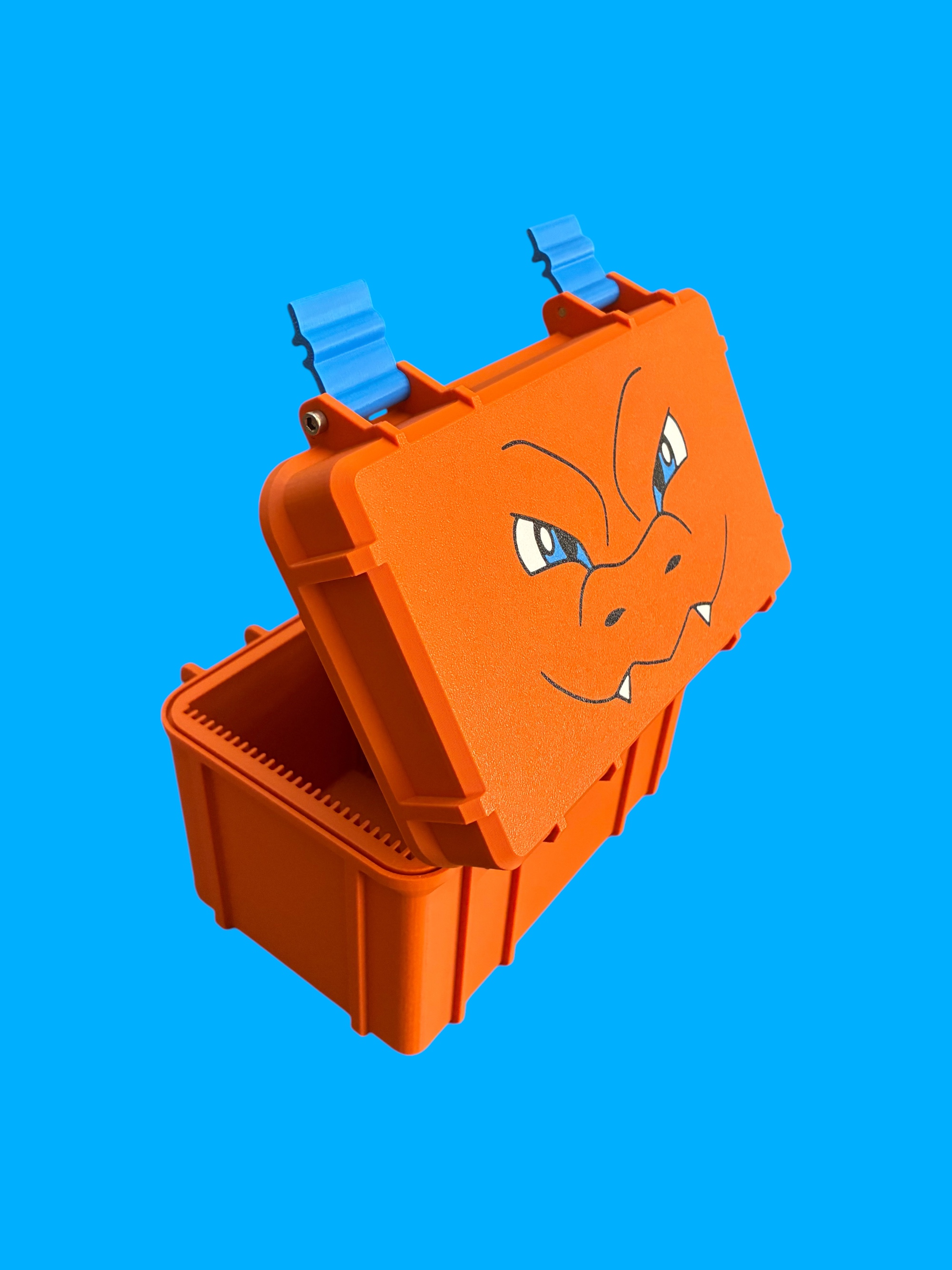 Orange rugged deck box with blue latches and a Charizard face graphic on the lid