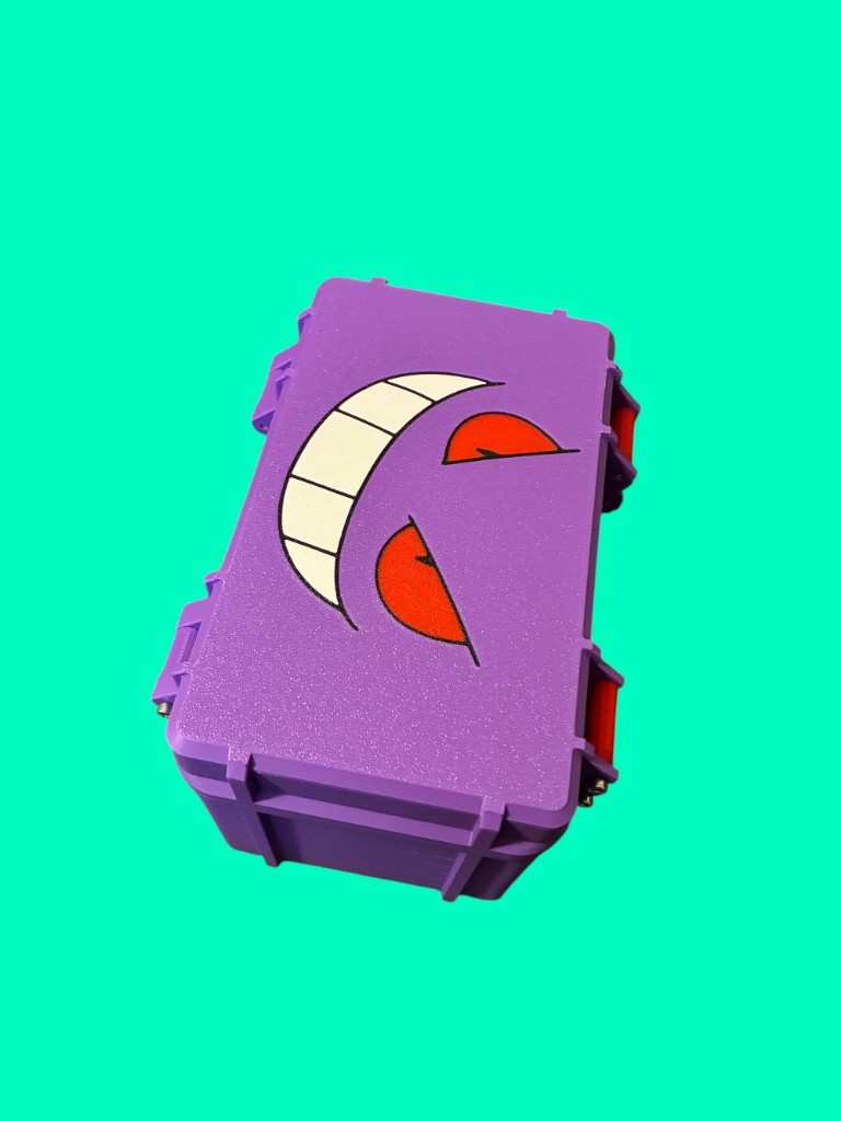 Purple rugged deck box with red latches and a Gengar face graphic on the lid