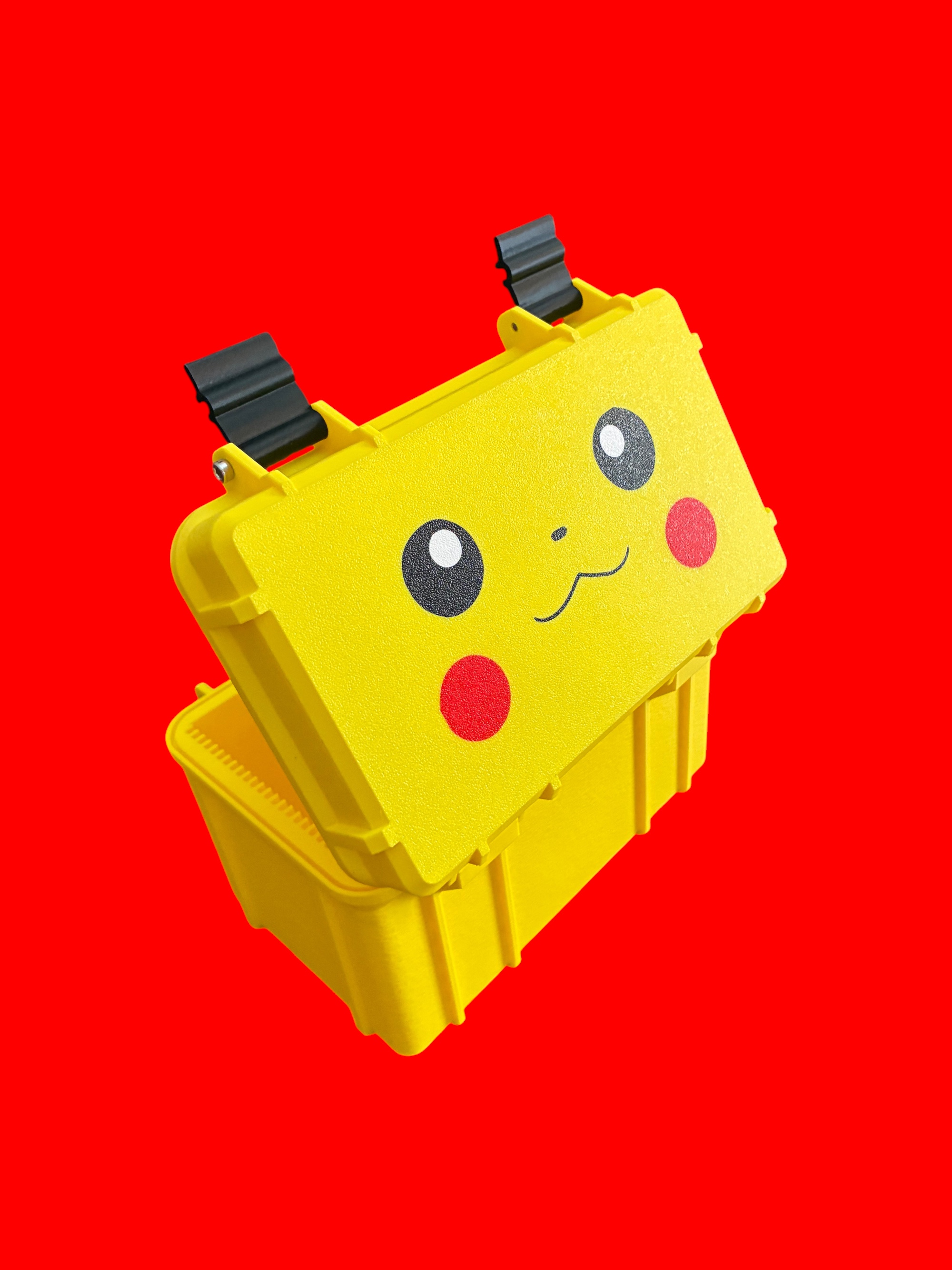 Yellow 3D-printed deck box with black latches and a Pikachu face printed on the lid