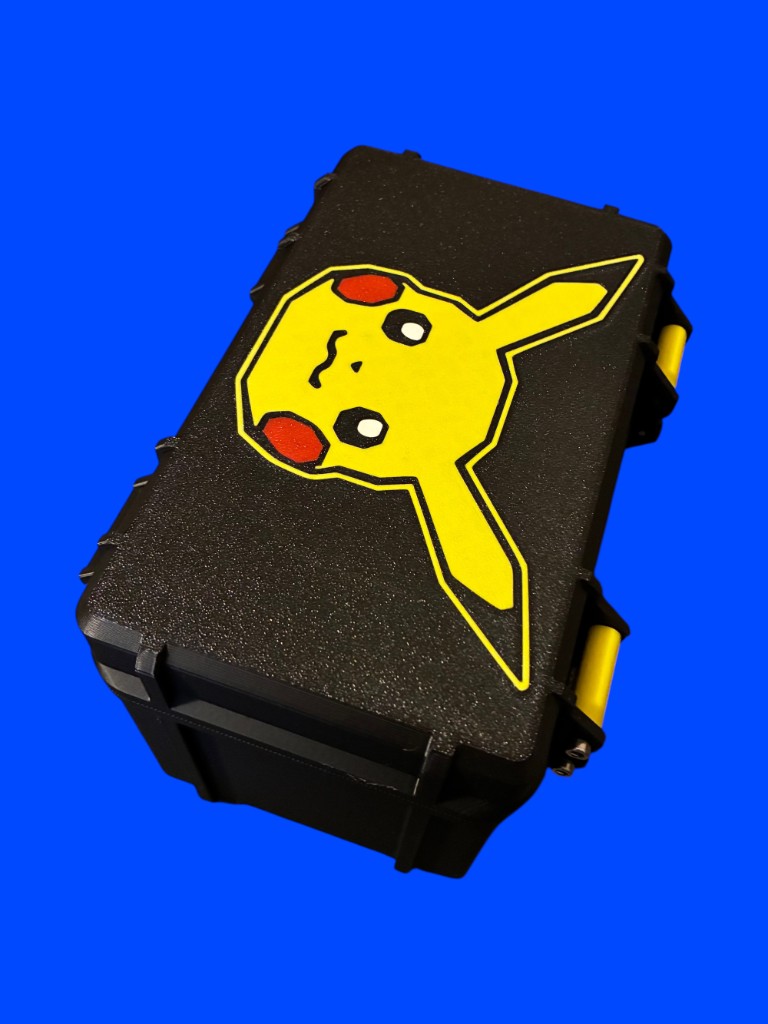 Black rugged deck box with yellow latches and a Pikachu face graphic on the lid