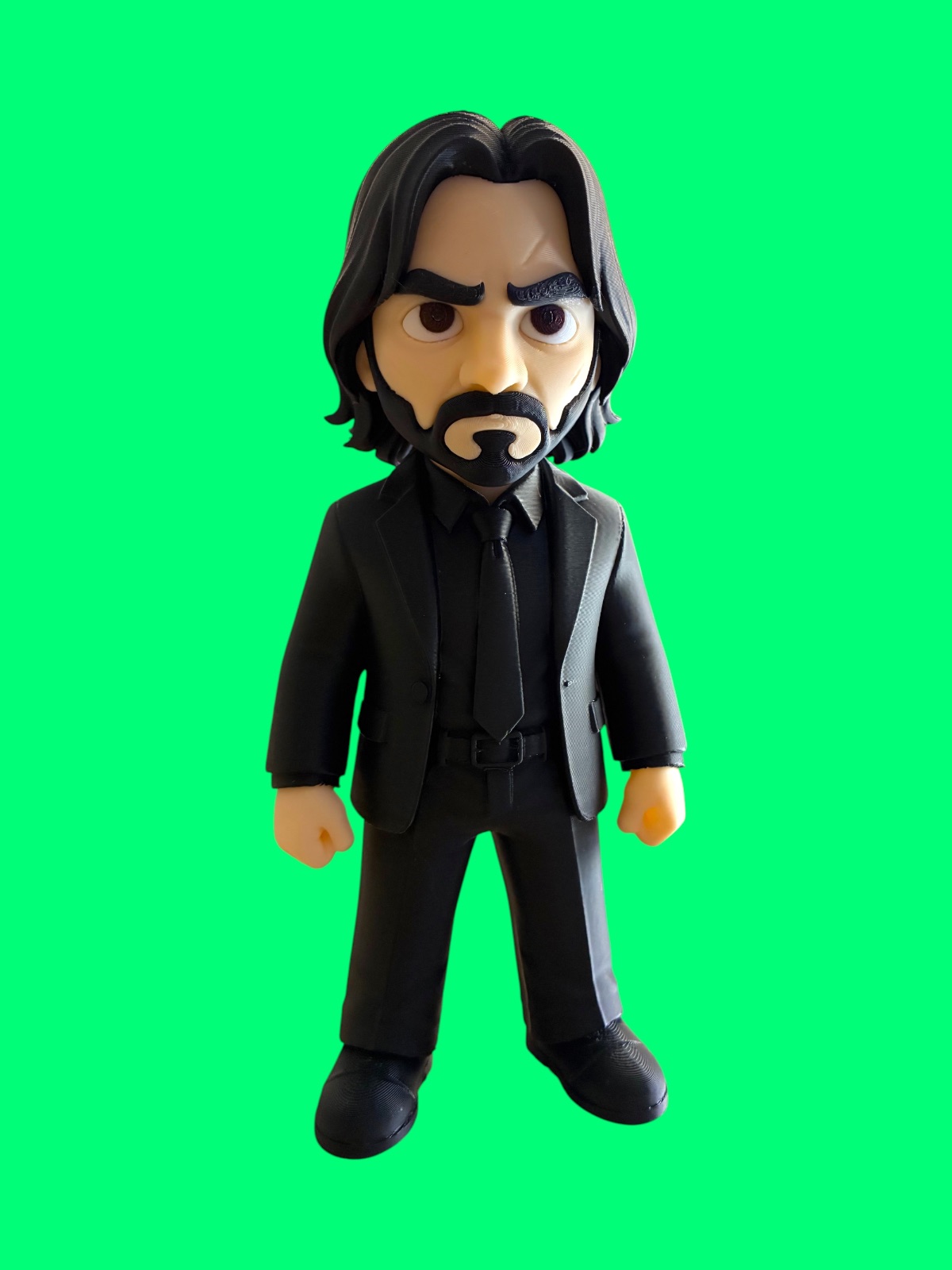 3D-printed John Wick collectible figure wearing a black suit and tie