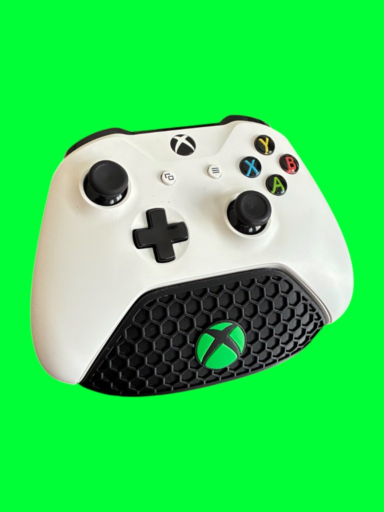 White Xbox wireless controller resting on a black honeycomb stand with a green Xbox logo, against a neon green background